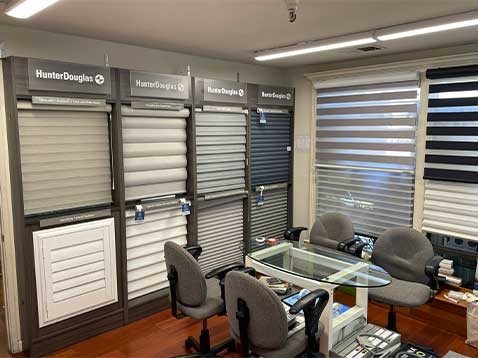 Store interior showcasing several different types of window coverings